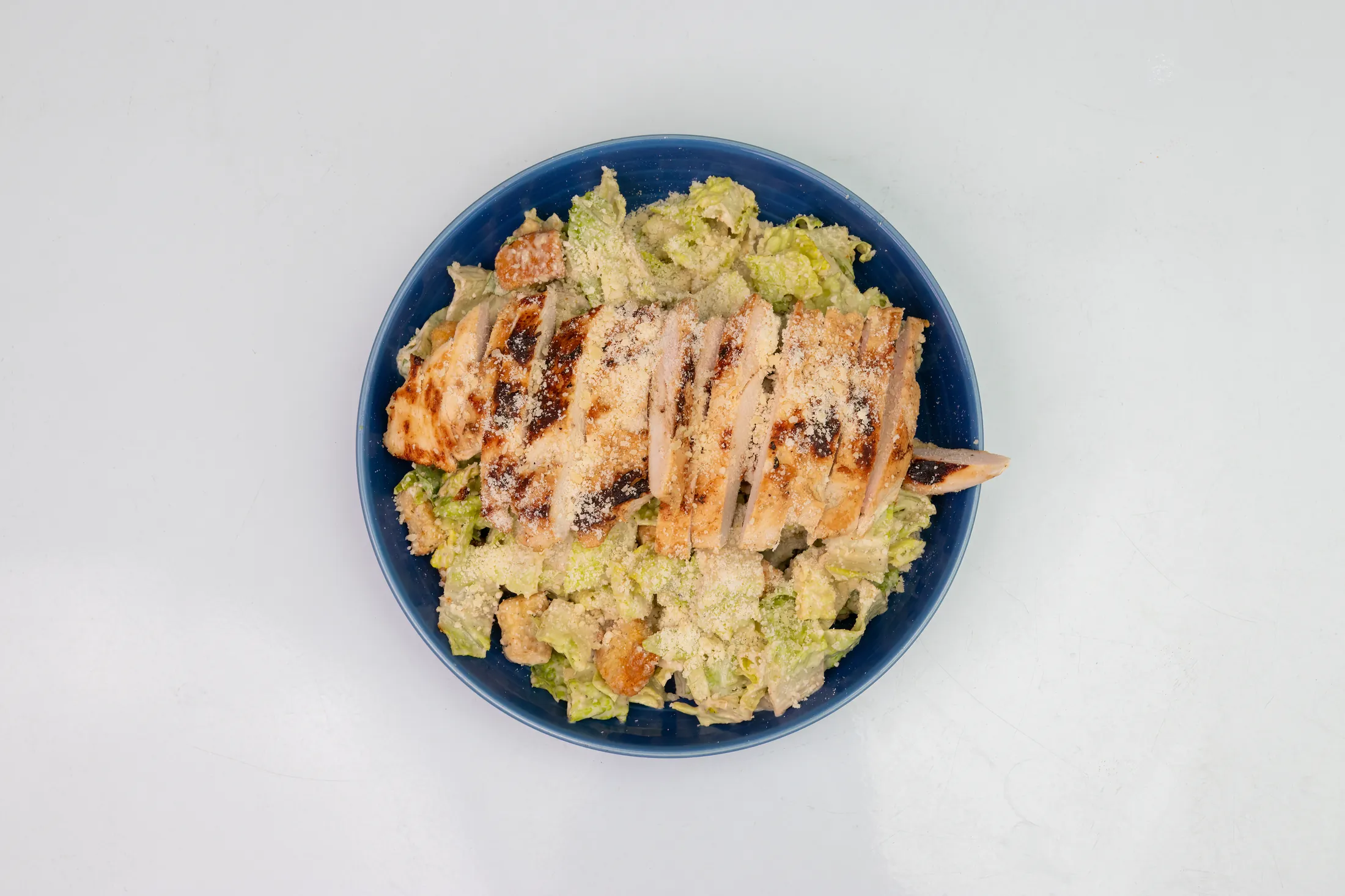 Chicken Caesar salad with romaine, parmesan, and grilled chicken at The Rusty Roost
